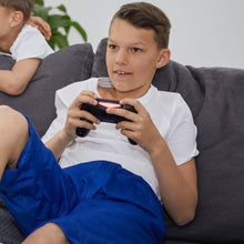 Load image into Gallery viewer, Children playing video games on a couch with gaming controllers wearing blue Pjama shorts .
