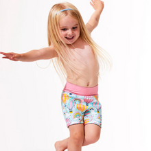 Load image into Gallery viewer, Child wearing colorful swim shorts with a white background