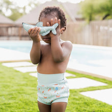 Load image into Gallery viewer, Child wearing a swim diaper holding a shark-shaped toy
